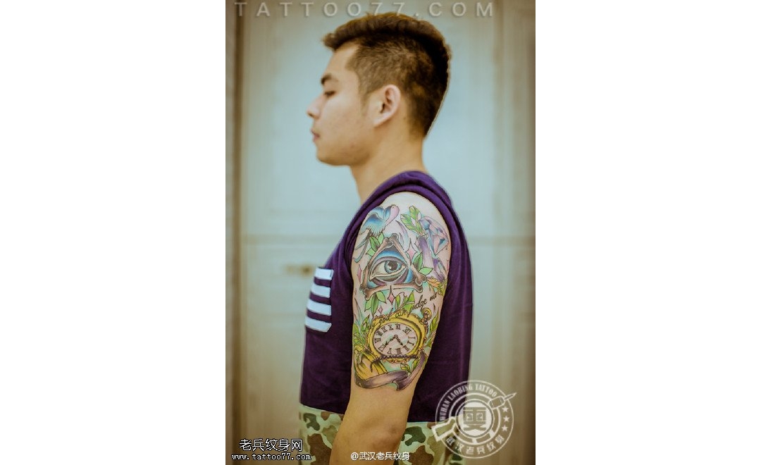 武汉专业女纹身师打造的大臂上帝之眼怀表纹身作品