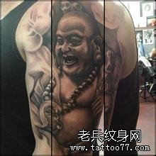 手臂弥勒佛纹身图案由武汉最好的纹身推荐
