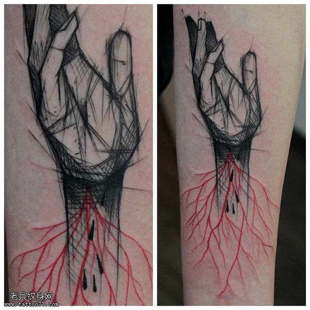 手臂上点刺的手纹身图案