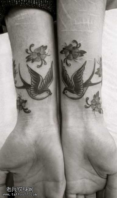 手臂燕子花朵纹身图案