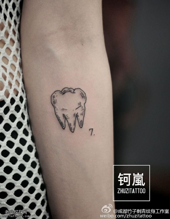 手臂的点刺牙纹身图案
