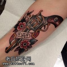 手臂上的一只手枪纹身图案